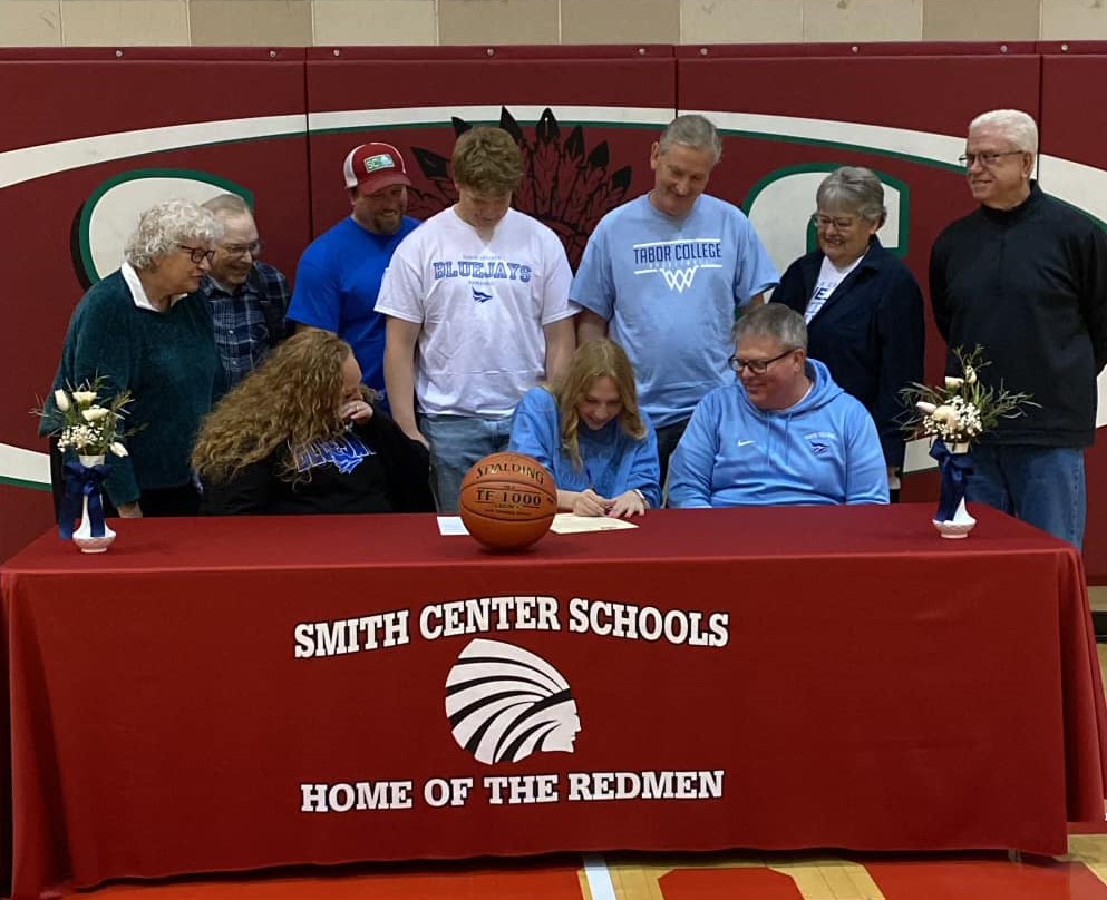 Dakota Kattenberg at her signing on Wednesday along with her family, Tabor women's basketball head coach Shawn Reed and Smith Center Lady Red head coach Nick Linn.