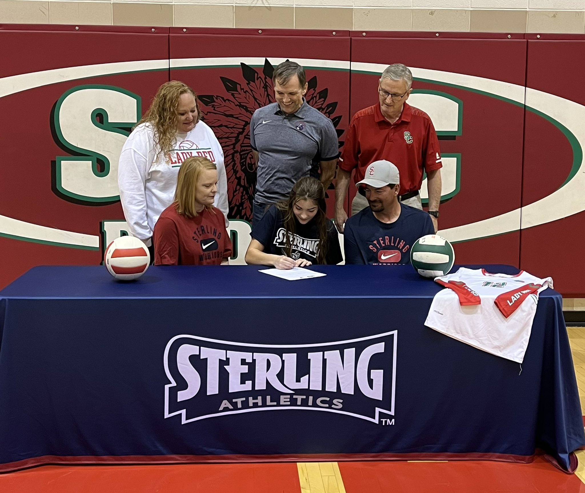 Pictured: Front (L to R): Becky Kirchhoff (Mom), Gracie Kirchhoff, Josh Kirchhoff (Dad); Back (L to R): Smith Center Assistant Coach Denyse Kattenberg, Sterling Head Coach John Harding, Smith Center Head Coach Nick Linn (Photo courtesy of Lady Red Volleyball)
