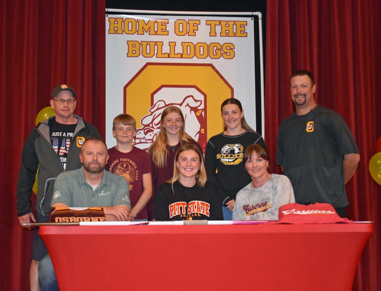Front row (L to R): Dad Cullen Riner, Gracie Riner, Mom Angie Riner; Back row (L to R): Osborne T&amp;F coach Steve Tiernan, Riner's siblings, Osborne AD Anthony Blair (Photo by Stephanie Baxa)