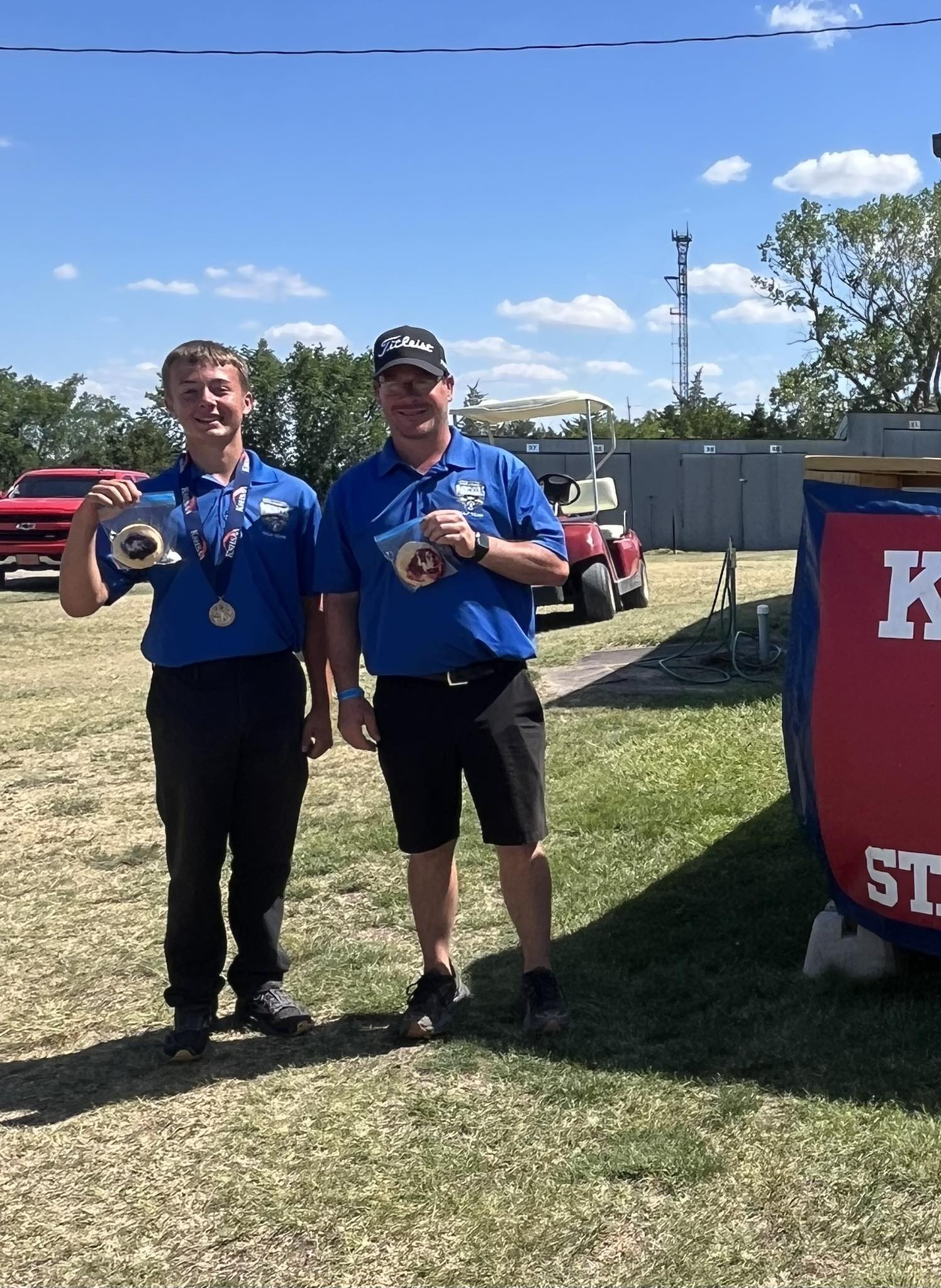 Bentley Melby (left) and Brent Melby (right) after winning the last KSHSHAA Sand Greens title in Mankato. Photo courtesy of Matthew Rice.